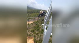 Vietnamese electrical workers do line repairs at terrifying heights