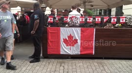 Canadians gather outside the Maple Leaf Bar to celebrate Canada Day
