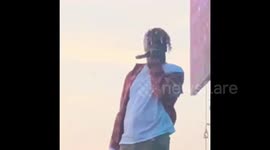 Rap star Lil Yachty poses for phone video on-stage at Veld