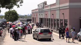 Crowds of people line up for hours in the hot sun for a free Canada day meal at Mandarin restaurants in Toronto and area