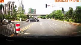 Lucky motorcyclist lands on his feet after crashing into car in China