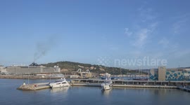 Time-lapse of barcelona port with the large cruise ship MSC Seaview docked and  other boats