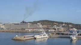 Time-lapse of barcelona port with the large cruise ship MSC Seaview docked and  other boats