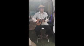 Filipino Musician playing Banduria