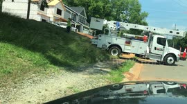 Truck between a rock and a hard place! US utility worker gets vehicle stuck