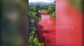 Discharged waste from mills in China's Yulin turns nearby river red