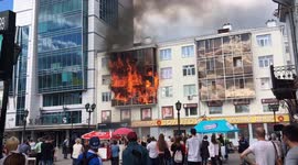 Crowd watches as flames engulf apartment block in Russian city