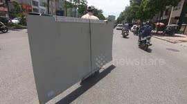 Man flew with the plastic plank? Bike riding with huge plastic plank on crowded road in Vietnam