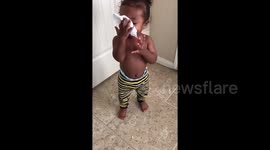 Cute baby imitates someone blowing their nose