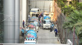 Bangkok is a city under construction and showing great signs of growth, here we see five cement mixers lined up to make a delivery at one construction site.