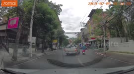Dangerous scooter rider kicks out at truck in near collision in Thailand
