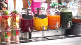 Honey bees take a break from work and visit a fruit juice vendor, some of them end up in the juice.