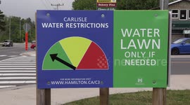 Lawns watered and sewer covers blown off along some flooding after 100mm of rain falls near Hamilton Ontario as thunderstorms break the heat wave