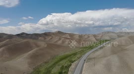 Drone video of Desert Mountain and road in the middle, South of Naryn, Kyrgyzstan.