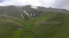 Drone video of Mountain  snow and river between,  South of Naryn, Kyrgyzstan.