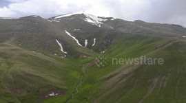 Drone video of Mountain  snow and river between,  South of Naryn, Kyrgyzstan.