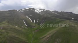 Drone video of Mountain  snow and river between,  South of Naryn, Kyrgyzstan.