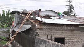 Debris from tornado hits power lines, panics onlookers in Indonesia