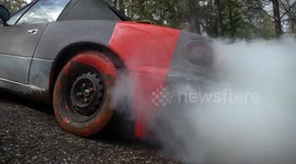 US car bursts into smoke after red paint is poured into fuel tank