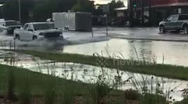 Truck pushes through on flooded street in Fargo ND
