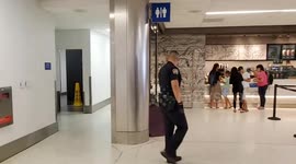 Starbucks calls lax airport police on a trying to take her clothes off in the store