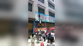 Four-year-old boy hanging from billboard falls down and caught by man in China