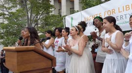New York: Chorus sings at 'Lights for Liberty' protest