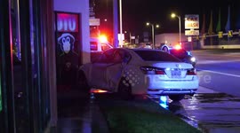Violent Crash at Intersection Causes One Vehicle to Almost Collide with the Wall of a Building, Signal Light Sheared
