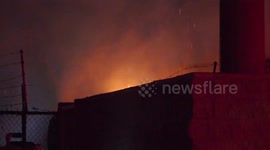 Firefighters Battle Fire Threatening Commercial Structure