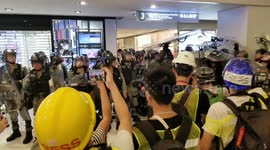 Moment Hong Kong police shield themselves from debris at shopping mall where bloody clashes occurred