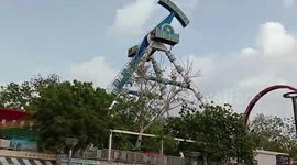 Amusement park ride crashes down in western India, killing two and injuring dozens