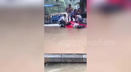 Residents in Chinese town rescue tourists trapped in SUV before it sunk into flooded river