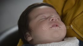These adorable pictures show a baby who was born with a marvellous head of thick black hair