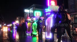 Thai locals celebrate Buddhist Lent with colourful parade that sees elephants wearing luminous attire