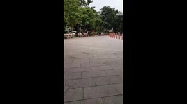 Exotic man exercising with a stone bench in the park
