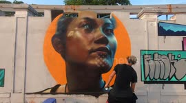 A group of street artists from England are drawing beautiful Graffiti paintings on the walls in Vietnam