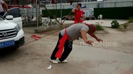 Kung fu master incredibly pulls two cars with just his ear in China's Shangqiu