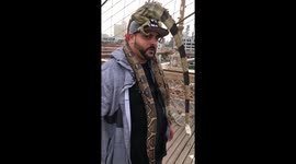 NYC man has an IGUANA for a hat and a SNAKE for a scarf
