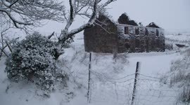 Derelict Stone Building With Falling Snow
