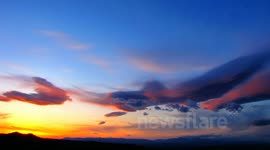 Colorful under-lit lenticular standing wave sunset timelapse V07405