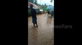 Storm Falcon leaves flooded streets behind after exiting the Philippines