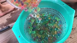 Slow motion of orbees into strainer bowl
