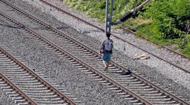 Refugees in Greece occupy train cars, creating an illegal camp alongside active train lines