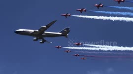 Flypast of a 747 in historic BOAC livery, alongside the Red Arrows