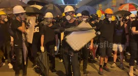Hong Kong protesters create noise before a police push forces crowds back