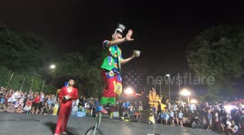 Man riding a unicycle and performs juggling is very skillful and fun