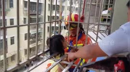 Firefighters rescue girl hanging from fourth-floor window in China's Ganzhou