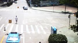 Heroic taxi driver chases down driverless car rolling down road in China and stops it