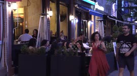 People out in the evening in Greektown on The Danforth in Toronto on the one year anniversary of the mass shooting that killed two and wounded 13