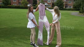 Girl who had red wine spilled on white outfit disguises disaster by pouring on more wine